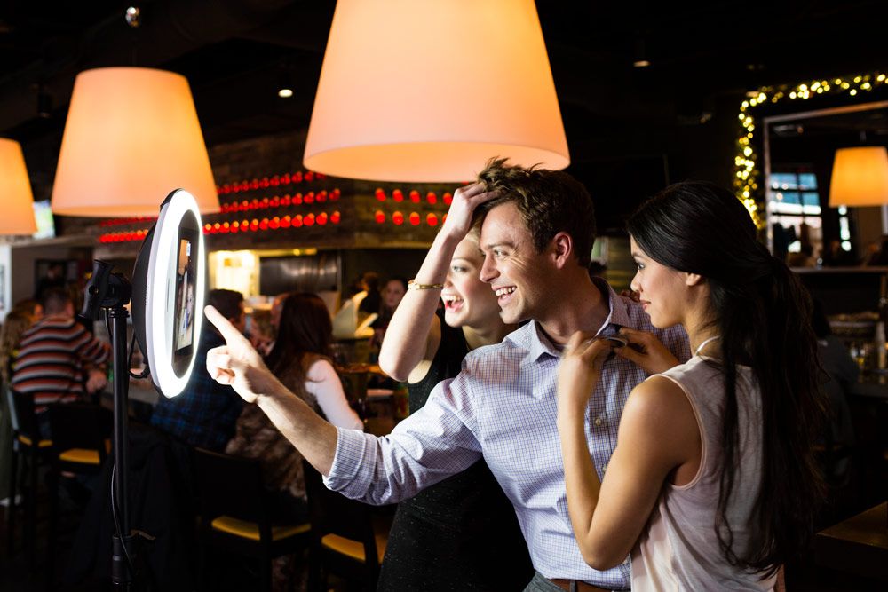 A couple posing in front of the booth camera