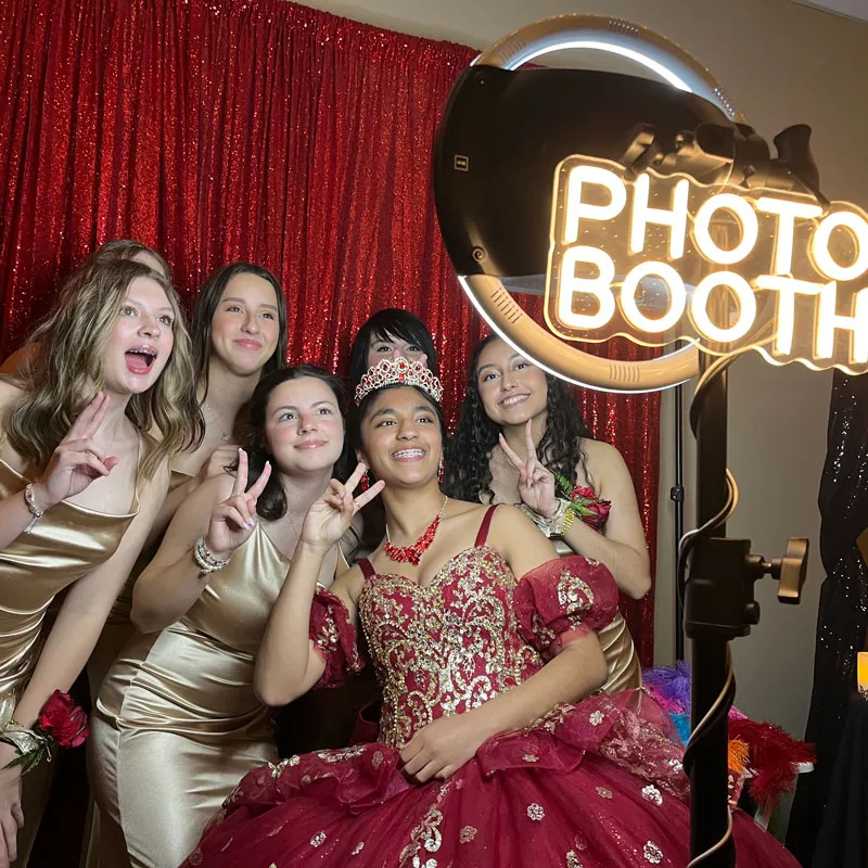A group of young women in formal wear posing in front of the camera
